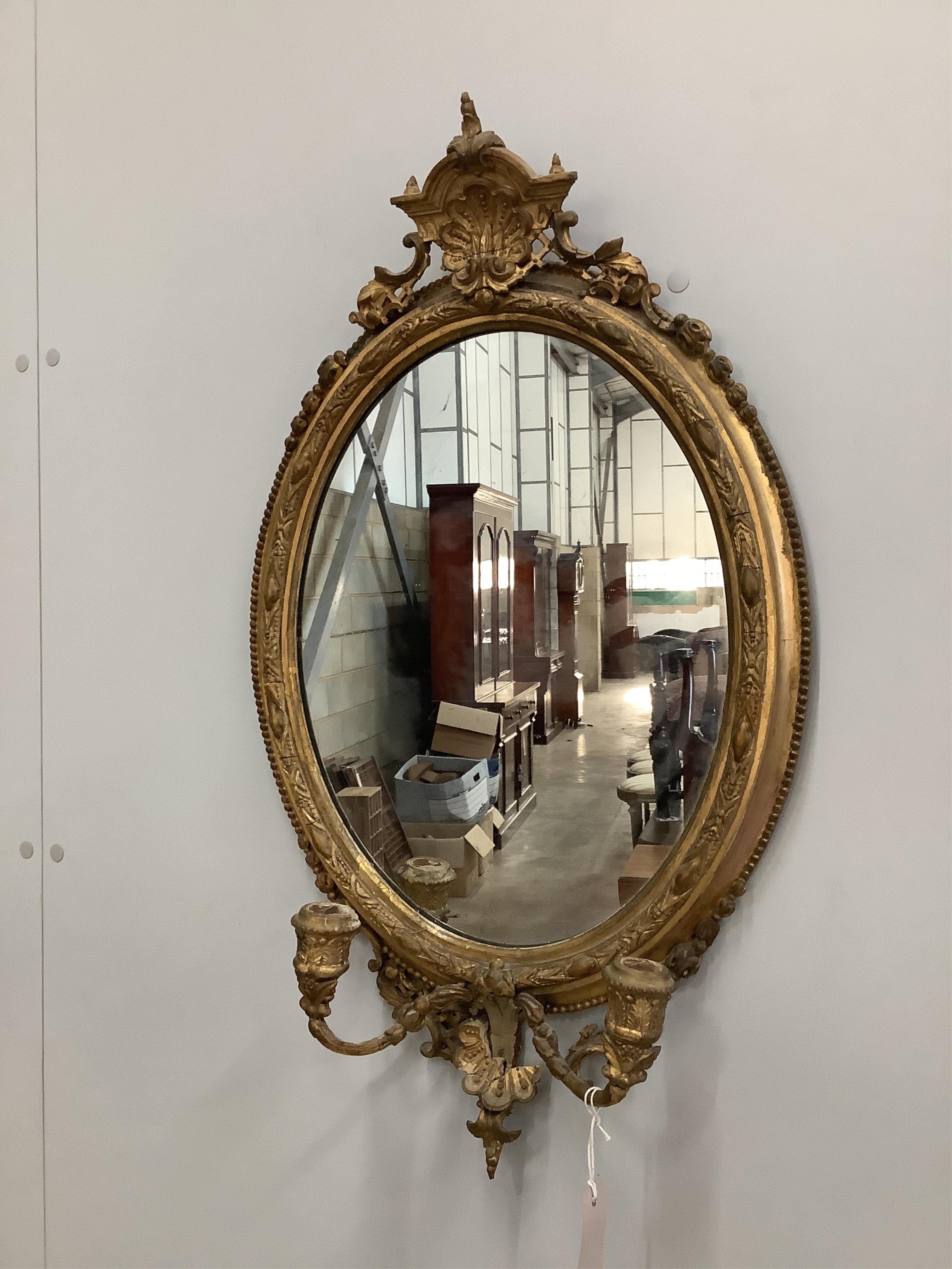 A Victorian giltwood and composition girandole wall mirror, width 43cm, height 73cm. Condition - poor to fair